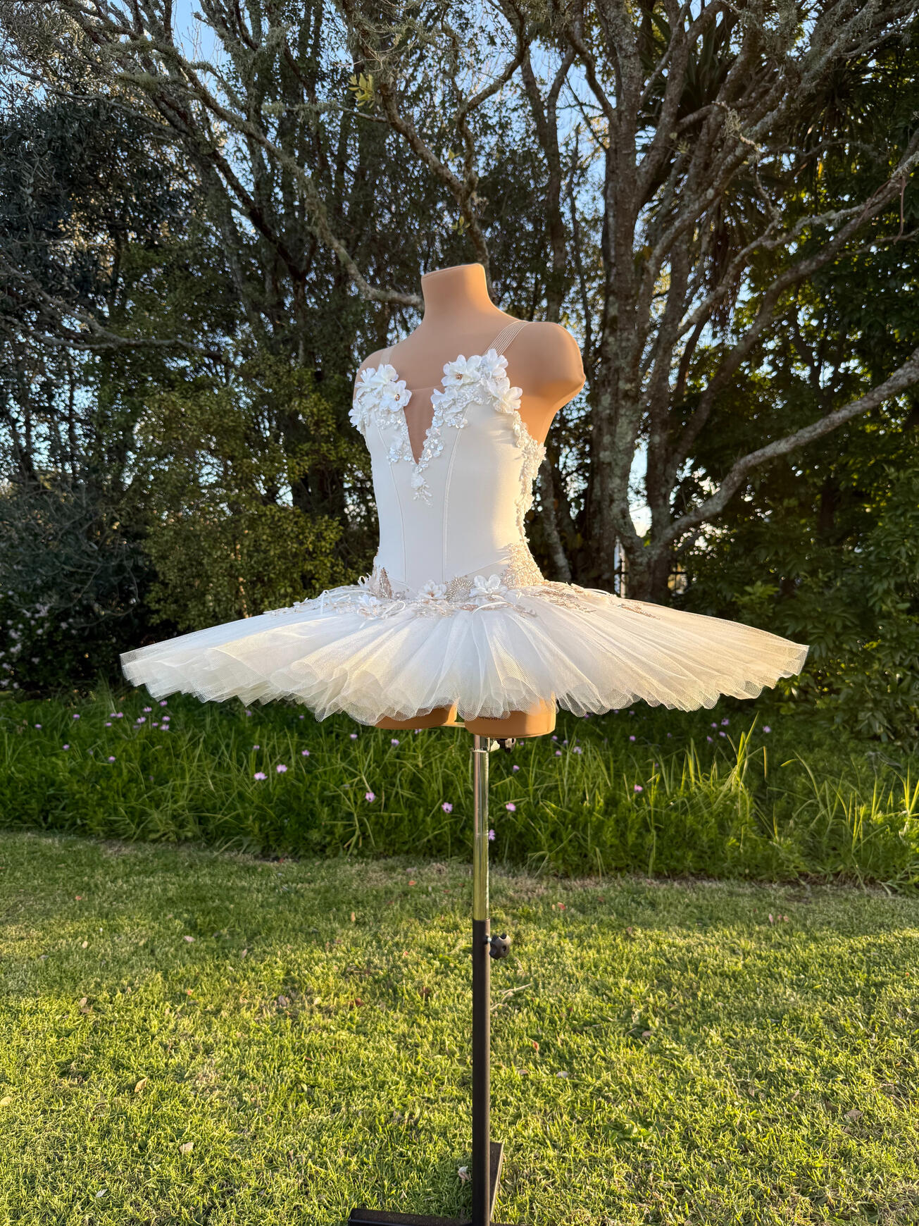 Stretch tutu with hand-rolled pleats, stiff net, 3D florals, rose gold, bronze and gold beaded lace and hand-sewn bows with smattering of rhinestones. Net edges have an airbrushed gold ombré.